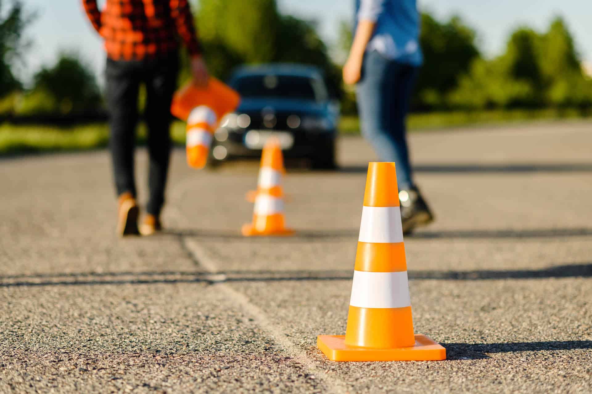 Instructor and student on road with traffic cones